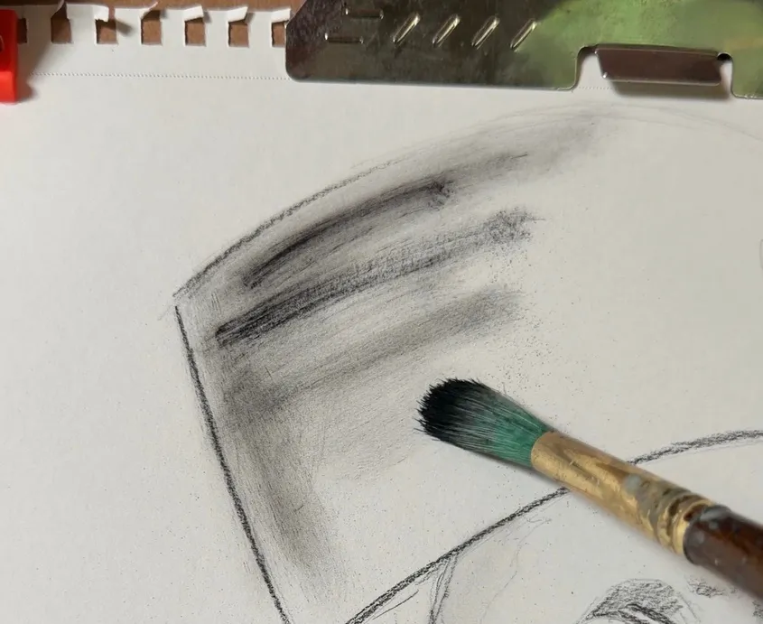 Close-up of charcoal brushwork texture on paper.